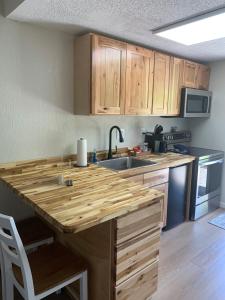 a kitchen with a wooden counter top and a sink at Lodge at Chalk Hill in Uniontown