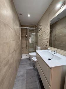 a bathroom with a sink and a toilet at Casa Azul in Villajoyosa +7 photos