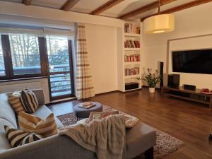 a living room with a couch and a tv at InOut Dom Olsztyn in Olsztyn