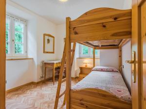 a bedroom with a bunk bed and a desk at Apartment Abete by Interhome in Rabbi
