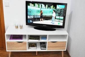 a tv on top of a white entertainment center at Villaviciosa in Villaviciosa