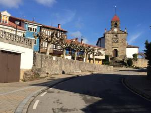 a street with a building and a clock tower at Villaviciosa in Villaviciosa