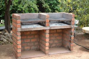 a brick oven with a bench on top of it at Tambuti lodge in Rundu
