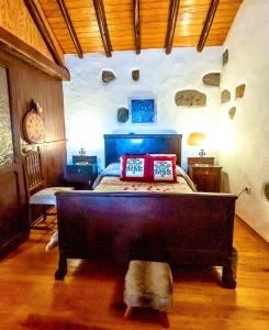a bedroom with a large bed in a room at Casa Rural Guiniguada in Santa Brígida +33 photos