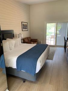 a bedroom with a large bed and a balcony at Lodge at Chalk Hill in Uniontown
