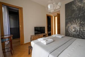 a bedroom with a bed with two towels on it at ReDavid House Villa in Torre a Mare