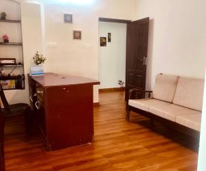a living room with a couch and a table at Ebenezer Stay in Trivandrum