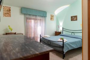 a room with two beds and a table in it at Il Nido del Falco in Montefalco +108 photos