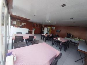 a restaurant with tables and chairs and pink tables at London House Hotel in Kemer +10 photos