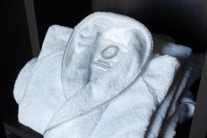 a white towel with a ring on top of it at ReDavid House Villa in Torre a Mare