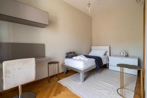 a bedroom with a bed and two stools in it at ReDavid House Villa in Torre a Mare +6 photos