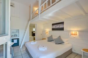 a bedroom with a large white bed in a room at Les Rizières in Saintes-Maries-de-la-Mer +113 photos