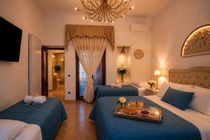 a hotel room with two beds and a tray of food at Maison Vico94 in Vico Equense