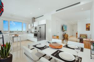 a kitchen and living room with a table and chairs at 2 BR Oceanview Condo Coral Shell 3e in Oranjestad