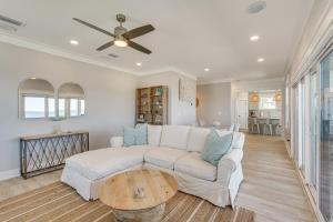 a living room with a white couch and a table at Windward Crest by Pristine Properties Vacation Rentals in Port Saint Joe