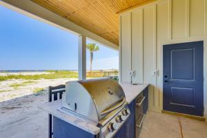 a kitchen with a grill in front of a beach at Windward Crest by Pristine Properties Vacation Rentals in Port Saint Joe