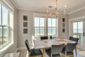 a dining room with a table and chairs and windows at Windward Crest by Pristine Properties Vacation Rentals in Port Saint Joe +138 photos