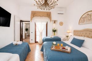 a hotel room with two beds and a tray of food at Maison Vico94 in Vico Equense