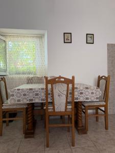a dining room with a table and chairs and a window at The Lakehouse in Krnjice