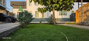 a car parked in a yard in front of a house at Archa hotel in Osh