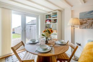 a dining room with a table and chairs and a window at 2 Bed in Llanfair oc-a30451 in Llanfair +20 photos