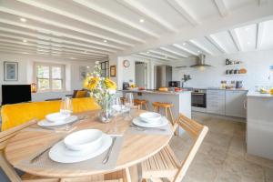 a dining room and kitchen with a table and chairs at 2 Bed in Llanfair oc-a30451 in Llanfair