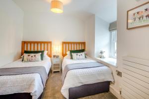 a bedroom with two beds and a window at 2 Bed in Llanfair oc-a30451 in Llanfair