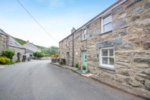 an empty street in front of a stone house at 2 Bed in Llanfair oc-a30451 in Llanfair
