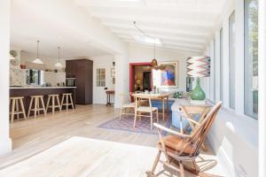 a kitchen and living room with a table and chairs at Sandown, Spacious and Stylish in Southwold in Southwold