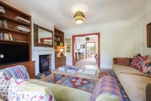 a living room with a couch and a fireplace at Sandown, Spacious and Stylish in Southwold in Southwold