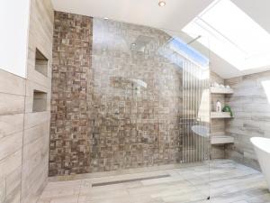 a bathroom with a shower with a glass door at Ty Haul in Rhosneigr +34 photos