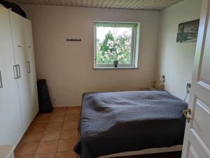 a bedroom with a bed and a window at FJ1603-Jaegerspris-Kystsvinget-3 in Jægerspris