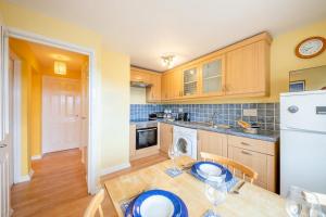 a kitchen with a table with blue plates on it at 2 Bed in Bamburgh oc-nb282 in Bamburgh +18 photos