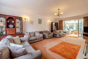 a large living room with couches and a tv at 4 Bed in Halesworth oc-willho in Halesworth