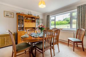 a dining room with a table and chairs and a window at 4 Bed in Halesworth oc-willho in Halesworth