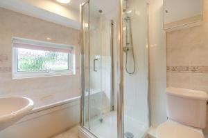a bathroom with a shower and a sink and a toilet at 4 Bed in Halesworth oc-willho in Halesworth +22 photos