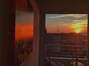 a view of a sunset from a balcony at Luxury penthouse with sea view in Makarska