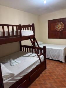 a room with two bunk beds in a room at Casa do Professor Hostel in Barreirinhas
