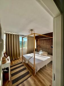 a bedroom with a bed with a canopy at Os Marias in Tomar