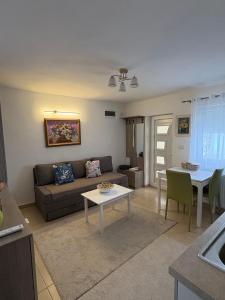 a living room with a couch and a table at Apartman Lala in Nova Varoš