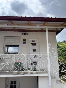 a balcony of a house with two plants on it at Apartman Lala in Nova Varoš