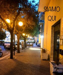 a street at night with a sign that reads sammo cut at Matera Central Nest in Matera