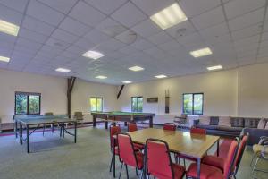 a large room with ping pong tables and chairs at Milton House Group Retreats in Bedford +66 photos