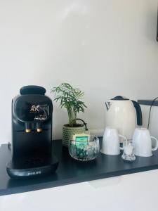 a black coffee maker on a black shelf at Brightside Suite in Kristiansand