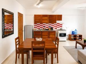 a kitchen with a wooden table and chairs in a room at Sol Dominicus 1 Apartamento con Cocina Solo Adultos in La Laguna