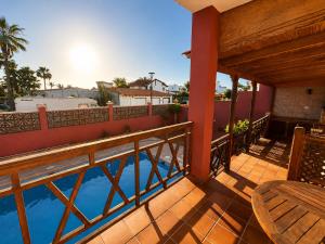 a balcony with a view of a swimming pool at Brisa Vacacional - Adults Only in Corralejo