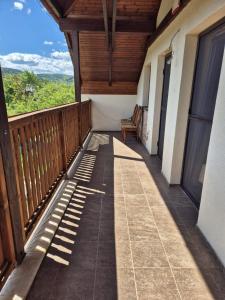 a balcony of a house with a wooden roof at Apartmán Ružiná in Ružiná