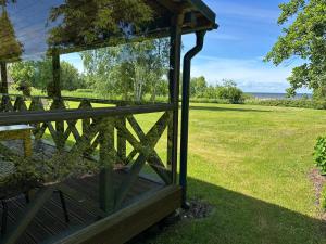 a view from the porch of a house with a fence at Vienmerjura in Benuži