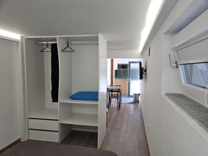 a room with white cabinets and a table and a chair at DiROMANE in Braga