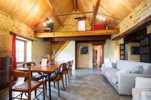 a living room with a table and a couch at Domaine de Cantegrel - Gîtes de Charme et Suite Troglodyte en Périgord in Vitrac